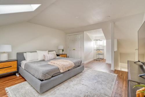 a bedroom with a bed in a room with white walls at Stay Portland - Perfect Portland Farmhouse Loft - Breweries & Bars in Portland