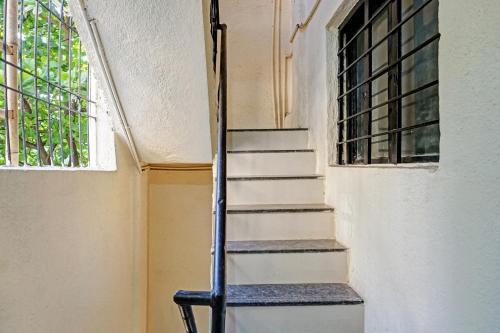 a staircase in a room with a window at Hotel O Le Serenity Beach View Resort in Kottakupam