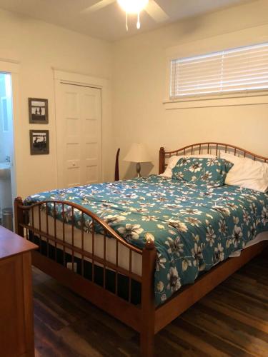 a bedroom with a bed with a blue and white comforter at The Chorus Frog - 8 Hollow in Cherry Valley
