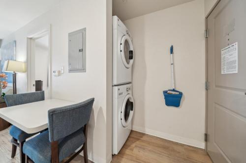 a laundry room with a table and a washer and dryer at Spectacular 1bedroom Apt At The Rim in San Antonio