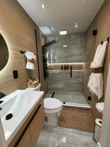 a bathroom with a sink and a toilet and a shower at VillaBellaWood in Fort Myers