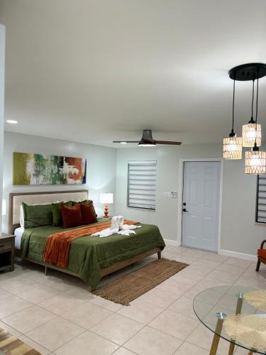 a bedroom with a bed with a green comforter at VillaBellaWood in Fort Myers