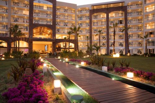 a hotel with a pathway in front of a building at Krystal Grand Los Cabos - All Inclusive in San José del Cabo