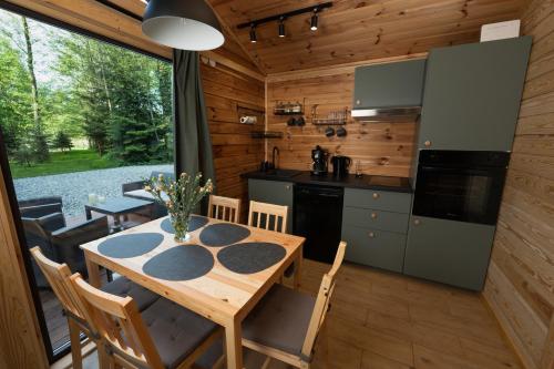a kitchen and dining room with a table and chairs at Stacja Natura in Radom