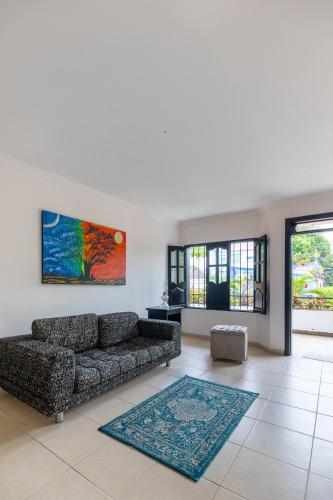a living room with a couch and a rug at Hotel Boutique Casa Pere in Cartagena de Indias