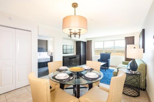 a living room with a table and chairs and a bedroom at The Grandview at Las Vegas in Las Vegas