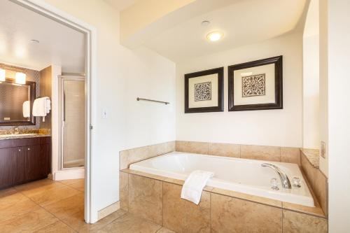 a bathroom with a tub and a sink at The Grandview at Las Vegas in Las Vegas