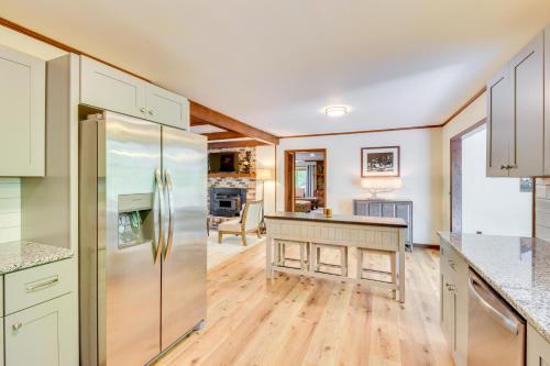 a kitchen with white cabinets and a stainless steel refrigerator at Deck and Game Room Mountaintop Hideaway in Tiger! in Tiger