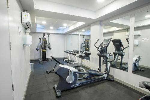 a gym with treadmills and ellipticals in a room at ibis Quito in Quito