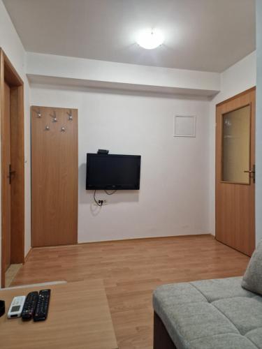 a living room with a flat screen tv on a wall at Apartments Vidikovac in Međugorje