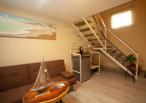 a living room with a couch with a sail boat on it at JM GUESTHOUSE Colonial in Santo Domingo