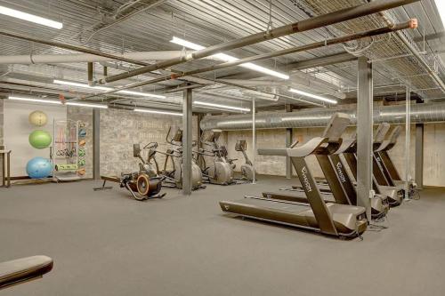 a gym with several treadmills and exercise bikes at Elegant 2BD near Historic Pabst Brewery - Fiserv in Milwaukee