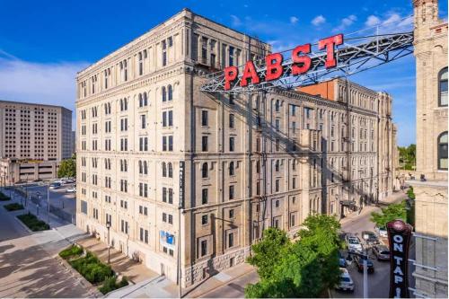 a building with a sign on top of it at Elegant 2BD near Historic Pabst Brewery - Fiserv in Milwaukee