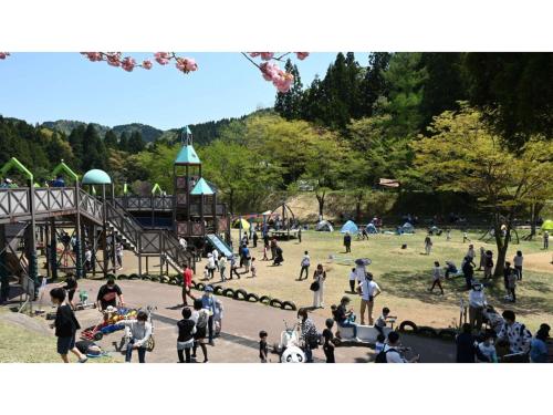 a group of people standing around a playground at TAKAYANAGI JONNOBI VILLAGE - Vacation STAY 90875v in Kashiwazaki