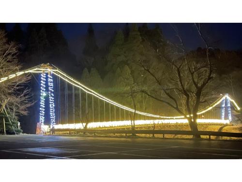 a bridge that is lit up at night at TAKAYANAGI JONNOBI VILLAGE - Vacation STAY 90842v in Kashiwazaki