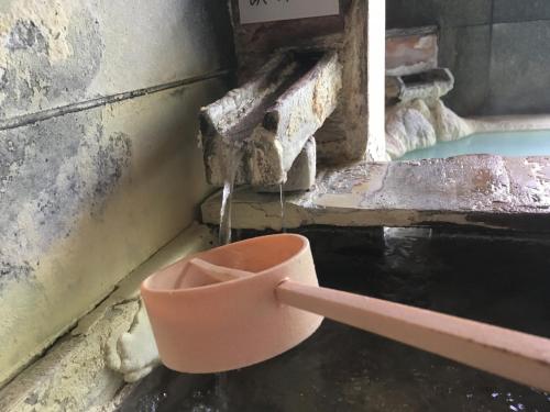 a pot sitting on the floor next to a water fountain at Shirafune Grand Hotel - Vacation STAY 85694v in Matsumoto