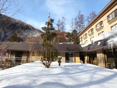 a fire hydrant in the snow in front of a building at Shirafune Grand Hotel - Vacation STAY 85694v in Matsumoto