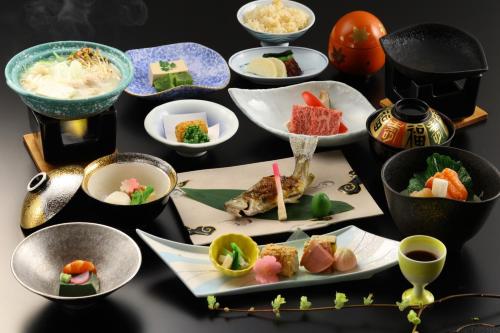 a group of plates of food on a table at Shirafune Grand Hotel - Vacation STAY 85694v in Matsumoto