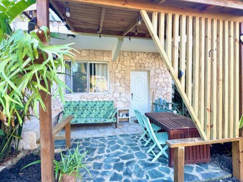 a patio with a bench and a table and a staircase at Cabarete Boutique Kite Hotel Garden Loft in Cabarete