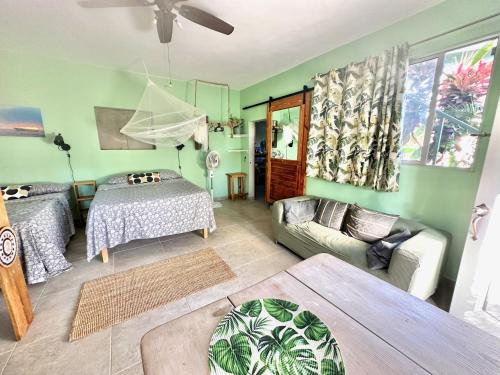a living room with a bed and a couch at Cabarete Boutique Kite Hotel Garden Loft in Cabarete