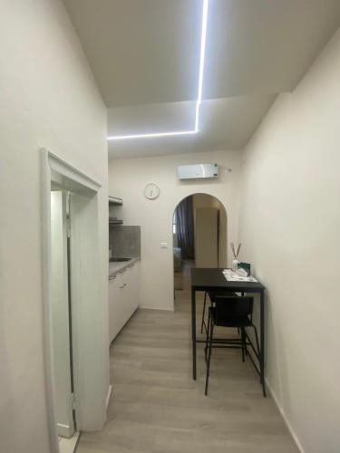 a dining room with a table and a kitchen at Da Mariolino in Arezzo