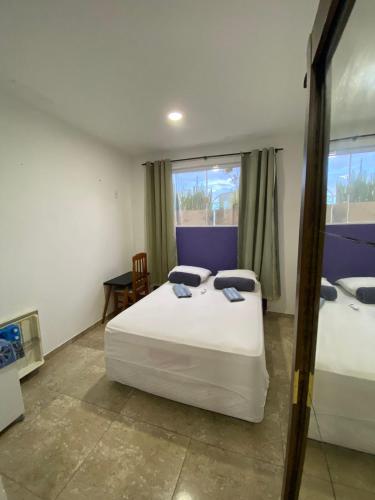 Ένα ή περισσότερα κρεβάτια σε δωμάτιο στο Suites Quebra Mar