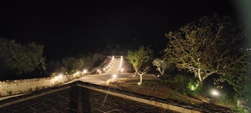 a set of stairs with lights at night at Antichi Saperi - Villa con piscina Cisternino in Cisternino