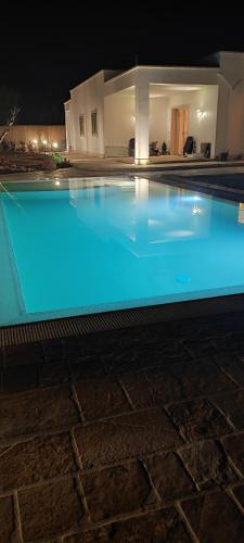 a swimming pool with blue lights in front of a house at Antichi Saperi - Villa con piscina Cisternino in Cisternino