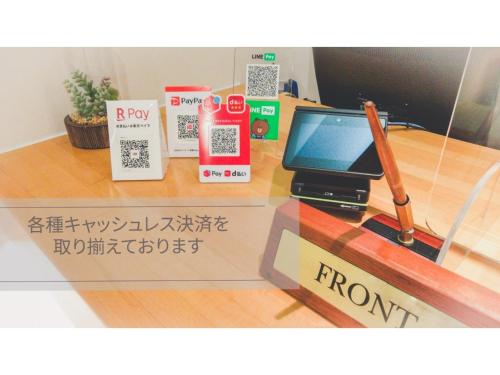 a glass counter with a laptop computer on a desk at Smile Hotel Matsuyama - Vacation STAY 04497v in Matsuyama