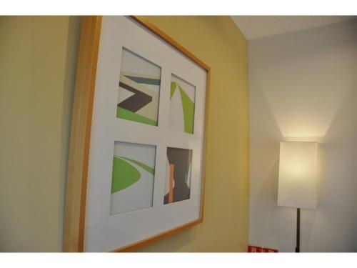 a picture hanging on a wall in a room at Smile Hotel Matsuyama - Vacation STAY 04497v in Matsuyama