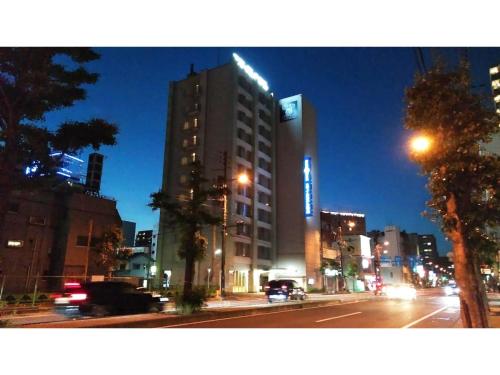 a tall building on a city street at night at Smile Hotel Matsuyama - Vacation STAY 04497v in Matsuyama