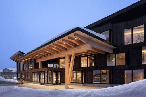 a building with a wooden structure in the snow at Humbird Hotel in Sandpoint