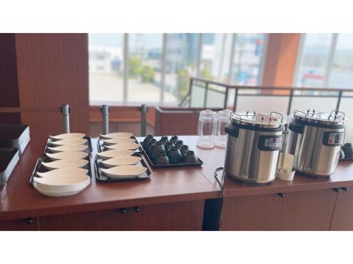 a counter top with a stove with plates and appliances at Sunnemu Hotel In Honjo - Vacation STAY 04625v in Yurihonjo