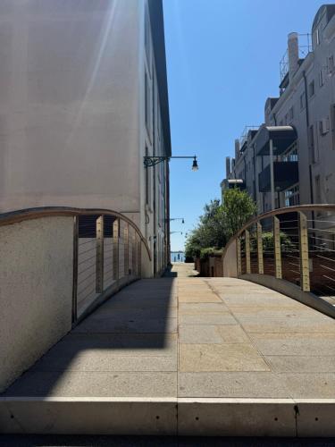 a bridge over a sidewalk next to a building at Deluxe Oliver's House in Venice