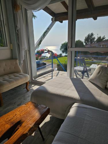 a bedroom with two beds and a view of the ocean at Aelia House Chalkidiki in Fourka