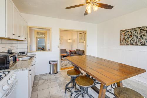 a kitchen with a wooden table and a ceiling fan at 1 Mi to Dtwn Schenectady Apt in Stockade District in Schenectady