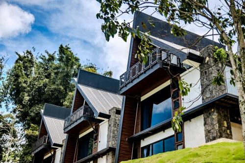 an exterior view of a house with balconies at Villa Bosque CR in Turrialba