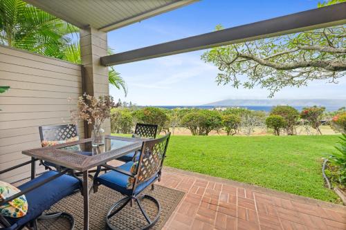 a patio with a table and chairs and a view at Kapalua Ridge Villa 2712 in Kapalua