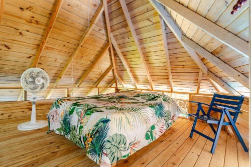 a bedroom with a bed and a chair in a attic at Cabarete Boutique Kite Hotel for up to 15 people in Cabarete