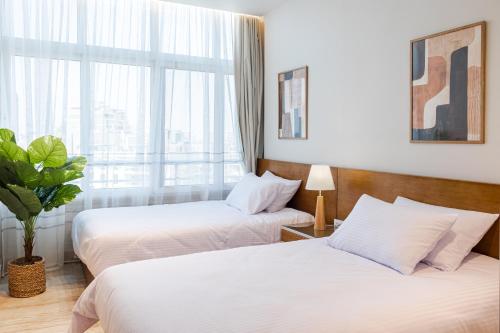 a hotel room with two beds and a window at Elegance Tower in Cairo