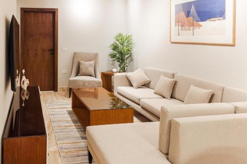 a living room with a couch and a chair at Elegance Tower in Cairo