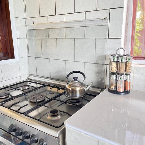 a tea kettle on a stove top in a kitchen at Beauty Sunset Faaa in Faaa