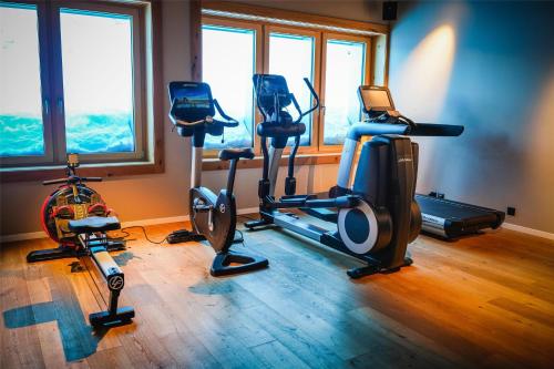 a gym with three exercise bikes in a room at Frutt Mountain Resort in Frutt