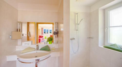 a bathroom with a sink and a shower at Hotel Bürglstein in St. Wolfgang