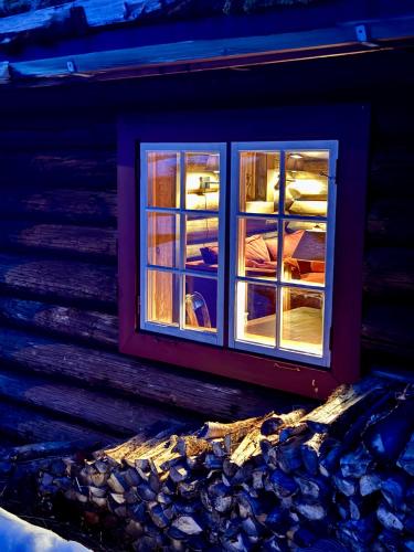 a window on the side of a building with beds at Geilo - Charming cottage with a stunning view in Geilo