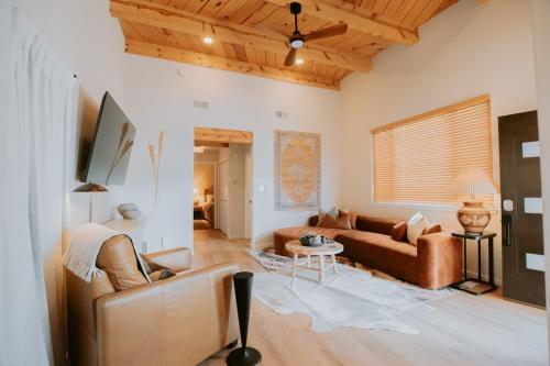 a living room with a couch and a table at Desert Sunset-Private Hot Tub-Pet Friendly-No Pet Fee! in Albuquerque
