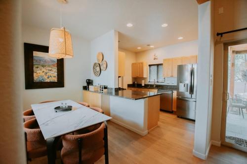 a kitchen with a table and a counter top at Desert Sunset-Private Hot Tub-Pet Friendly-No Pet Fee! in Albuquerque