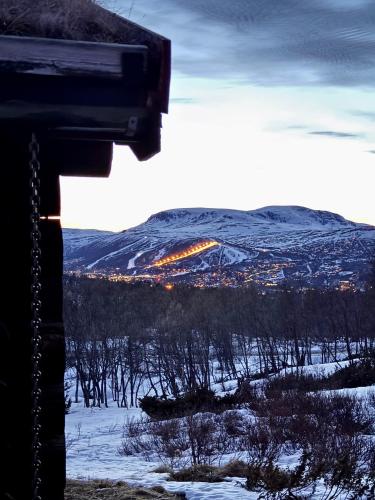 a view of a snow covered mountain with a city at Geilo - Charming cottage with a stunning view in Geilo