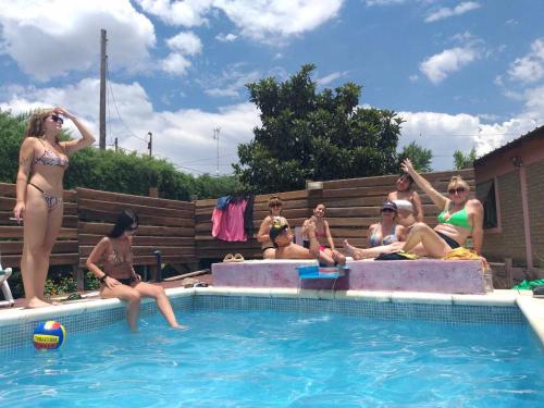 a group of women sitting around a swimming pool at CABAÑAS SANTA RITA - Tanti, Córdoba in Tanti