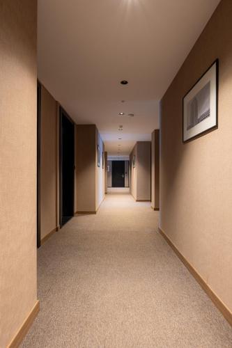 an empty hallway in a building with brown walls at Downtown Apartments in Pristina